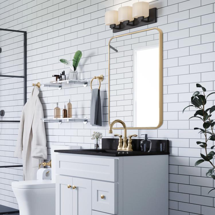 gold mirror in black and white bathroom